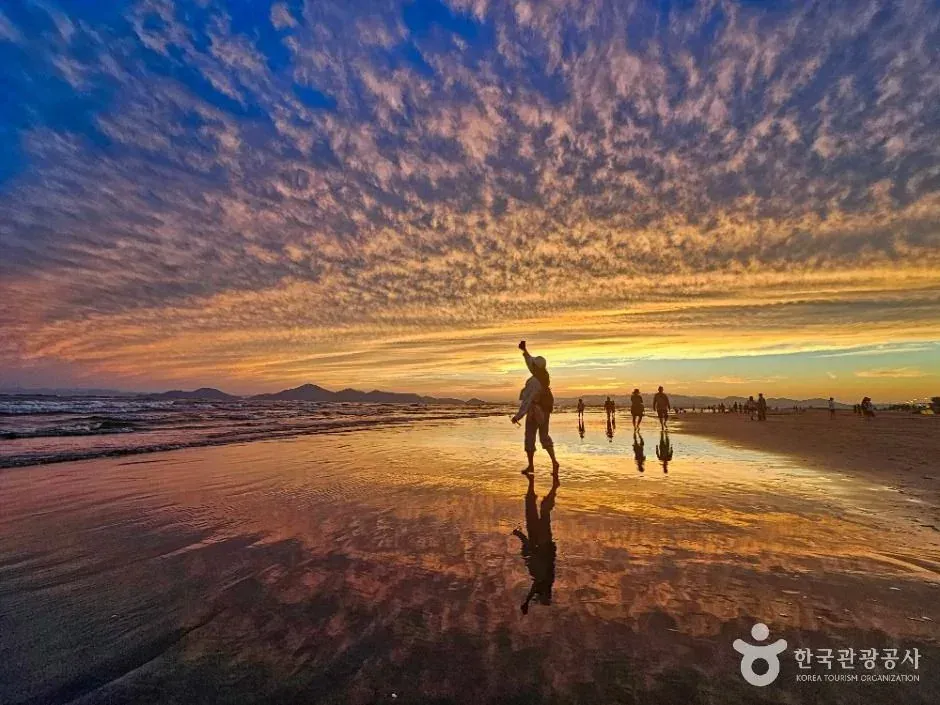 Walkers at Dadaepo Beach near sunset