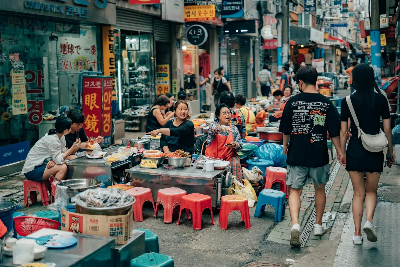 People walking through a fish market in Busan