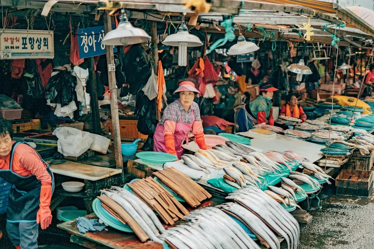 People gathered at a Busan market stall
